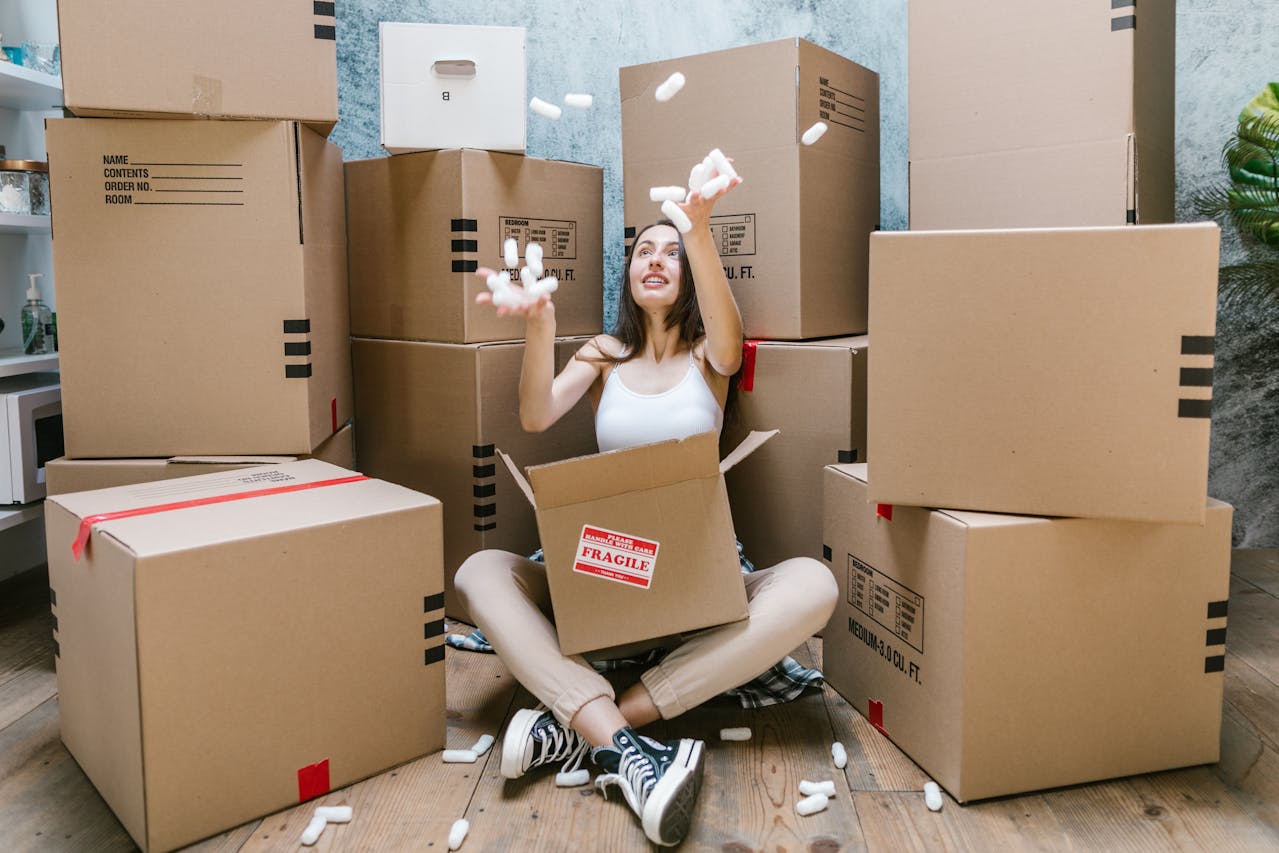 woman in a pile of cardboard boxes