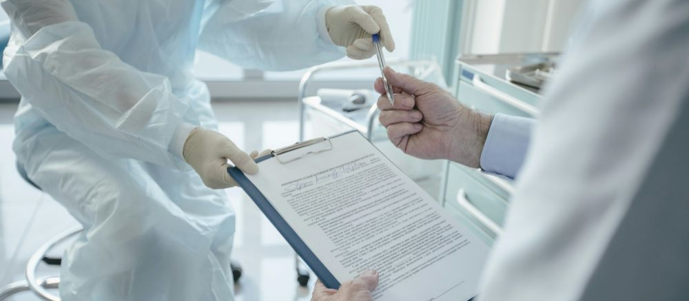 A woman giving a contract to a man